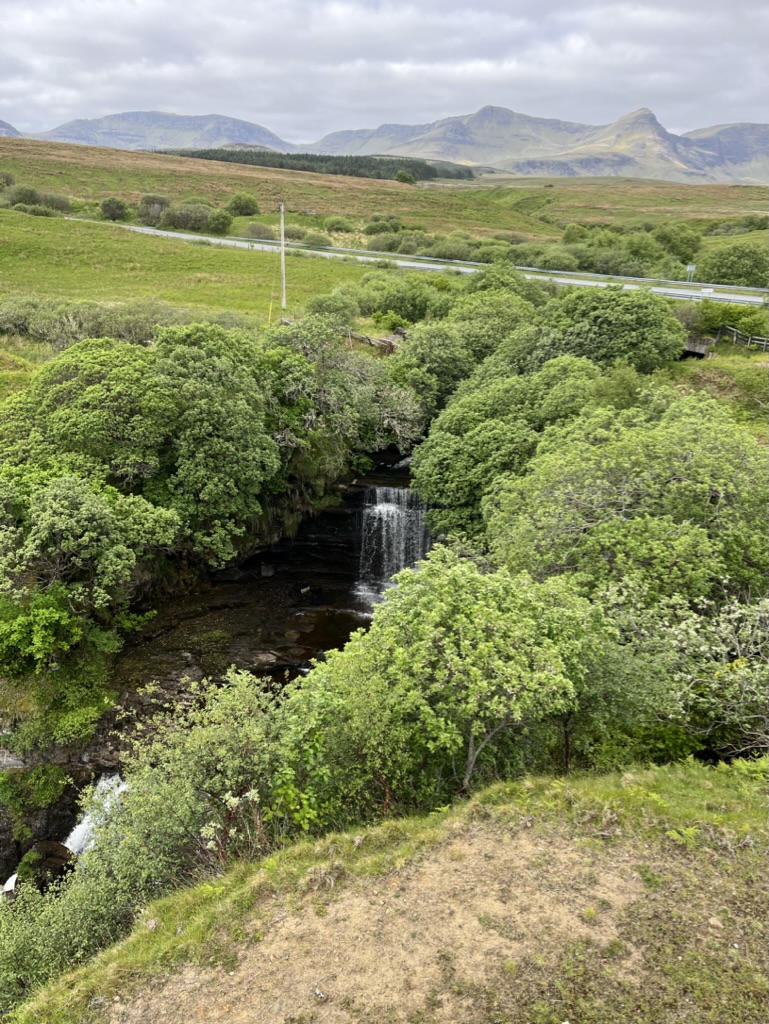 Waterfall cascading down a hillside in Scotland